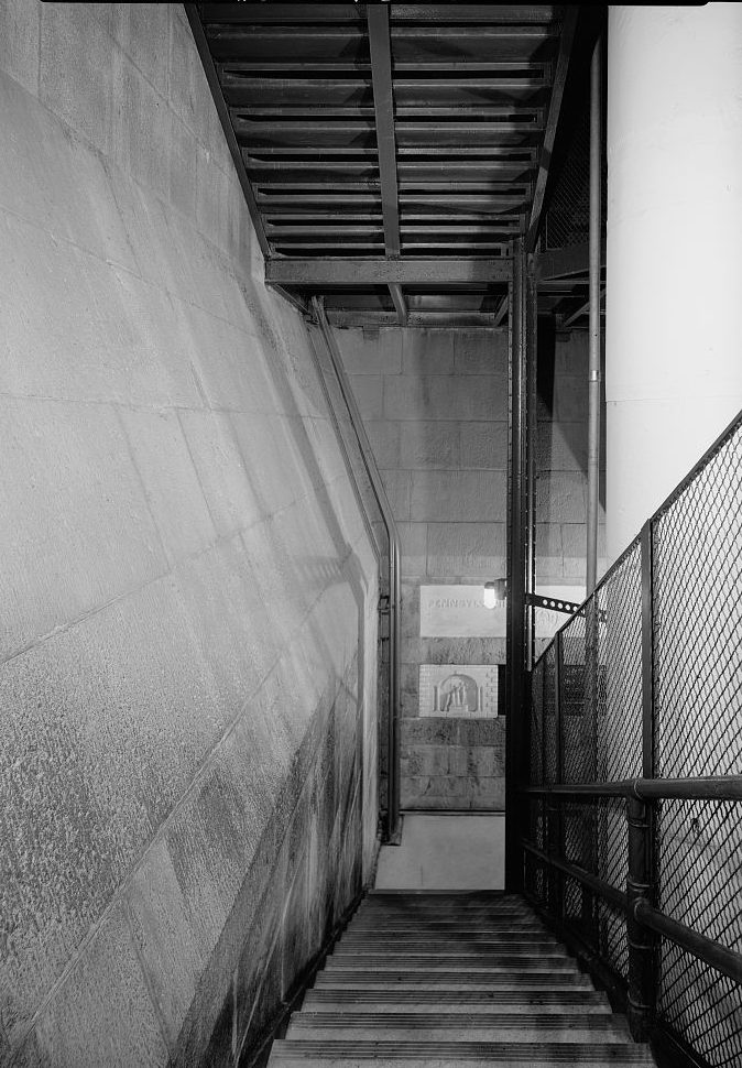 Black-and-white photographs depicting the battered walls inside the Washington Monument at level 150. The images reveal the transition between the monument’s stone and metal construction, with visible seams and rough textures marking this structural change. The space is narrow and shadowy, with hints of historic wear on the stone surfaces.